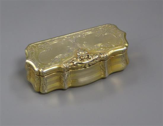A 19th century Austrian gilt white metal snuff box of shaped rectangular form, engraved and engine-turned, Vienna 1847, 92mm.